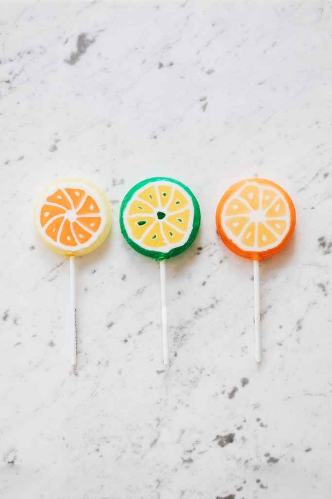 assorted colorful lollipops on marble surface