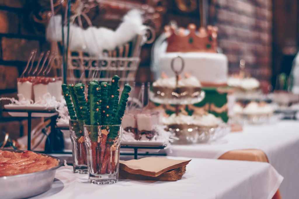 baked bread beside clear drinking glass on white table cover