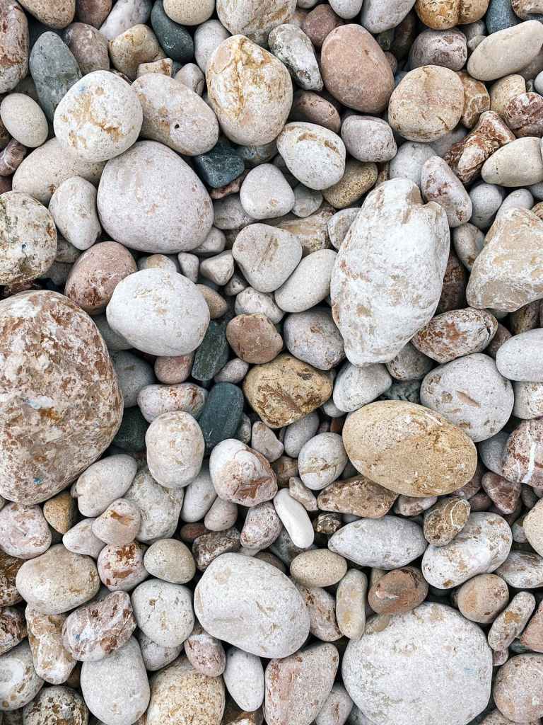 different pebbles on beach as abstract background
